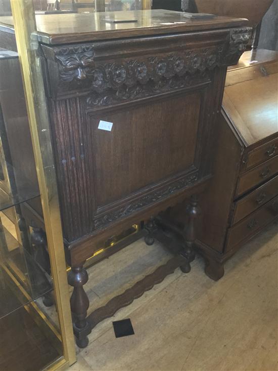 Carved oak cabinet with drop front and drawer(-)